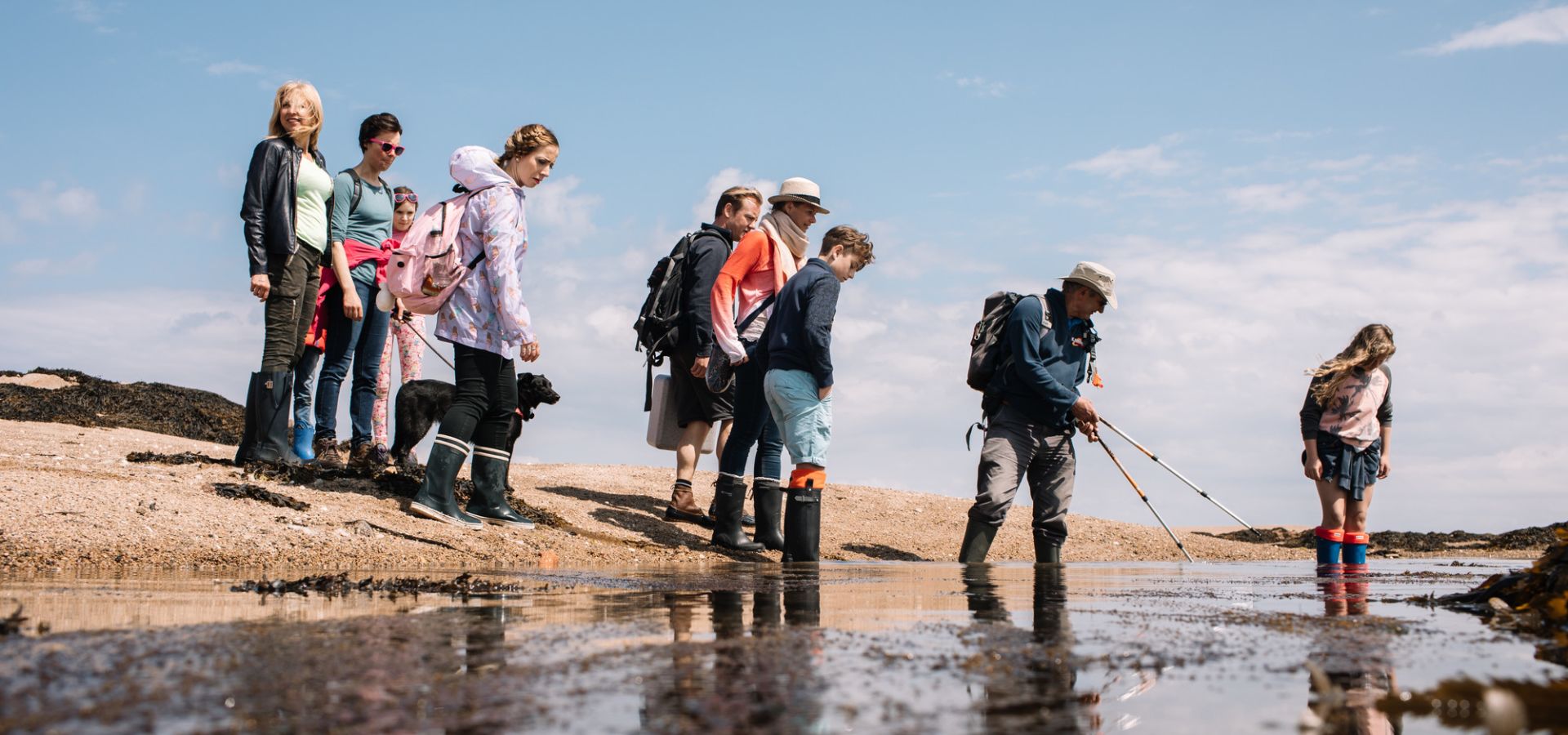 A groups of walkers at low tide on a seabed walk with Jersey Walk Adventures